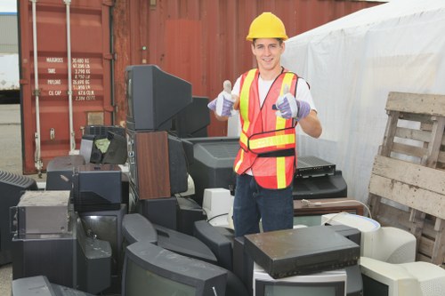 Professional flat clearance team removing furniture in an East London flat