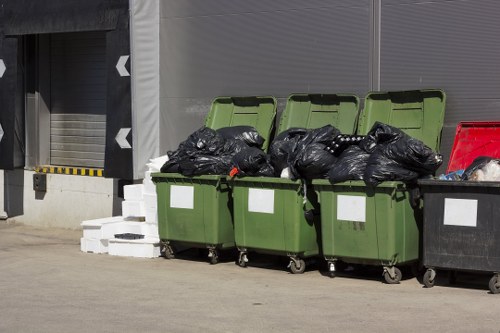 Waste clearance truck collecting refuse in East London